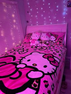 a bedroom with hello kitty bedding and pink lights