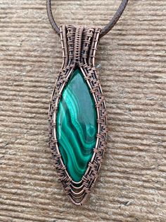 This nicely colored Malachite simple pendant was hand crafted by me with love. Made with 99% copper that has been oxidized to give it a vintage appearance. It features a nicely color patterned, green Malachite. This design is feminine and masculine so would be a great gift for a man or a woman. It is a bigger piece All my pendants come with a simple 20 inch black corded necklace. I can do custom orders on all of the designs in my shop. If you would like a different stone in a particular setting/ Handmade Copper Wire Pendant Jewelry, Copper Oval Pendant Necklace For Gift, Copper Oval Pendant Necklace Gift, Copper Necklace With Oval Pendant For Gift, Spiritual Hand Forged Oval Pendant Jewelry, Handmade Copper Wire Round Pendant Necklaces, Handmade Copper Wire Necklace With Round Pendant, Handmade Copper Wire Round Pendant Necklace, Adjustable Copper Amulet Jewelry