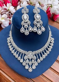 Add a touch of glamour and sophistication with this high quality necklace set in beautiful clear stones. The stones in this set bling and look close to the real thing. This set is sure to make heads turn!  It features an adjustable necklace and a pair of earrings. It can be paired perfectly with both ethnic and western outfits.  In case of any queries, please feel free to reach out. Happy shopping! Diamond White Cubic Zirconia Bridal Sets, Dazzling White Cubic Zirconia Bridal Sets, Dazzling Cubic Zirconia Bridal Sets, Anniversary Bridal Sets With Sparkling Cubic Zirconia, Silver Cubic Zirconia Bridal Sets With Elegant Design, White Cubic Zirconia Jewelry Set With Brilliant Cut, Elegant Silver Cubic Zirconia Bridal Sets, Dazzling Cubic Zirconia Bridal Sets With Elegant Design, White Brilliant Cut Cubic Zirconia Jewelry Sets