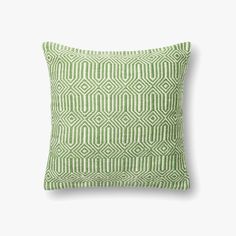 a green and white pillow on a white background