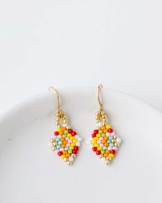 Add a little fun to your jewelry box! The Beaded Confetti Earrings are hand strung by Vi Bella Artisans in Haiti. Colors will vary. Choose from two sizes. Details: Handbeaded by Vi Bella Artisans in Haiti Small - 1 1/4" drop. Large - 1 5/8" drop. Multi-color pattern will vary. Confetti Earrings, Earrings Patterns, Beaded Earrings Patterns, Earring Patterns, Hand Beading, Haiti, Beaded Earrings, Color Patterns, Confetti