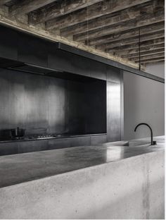 an industrial style kitchen with concrete counter tops