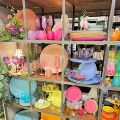 colorful dishes and plates on display in a store