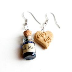 "These earrings feature Alice in Wonderland inspired \"Eat Me\" cookie and \"Drink Me\" potion charms. Both hangs on a silver tone , nickel free french hook. The \"Eat Me\" heart cookie charm measures 1.5 cm and the bottle pendant measures about 2 cm tall. The entire earrings length is 5 cm." Drink Me Potion, Silly Earrings, Alice Halloween, Crazy Earrings, Alice In Wonderland Diy, Alice In Wonderland Gifts, Alice In Wonderland Inspired, Heart Cookie, Alice In Wonderland Costume