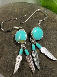 * Handmade item *925 Sterling silver * Gemstone: Kingman Turquoise *Dangle drop Earrings * 8mm Round Stone with 2 Feathers *Free gift box *Free shipping in USA *Ready to ship *Thank you for looking and check out more items in my Etsy shop for more great items and deals! *Https://www.etsy.come/shop/abq925 Adjustable Turquoise Jewelry With Feathers, Turquoise Feather Jewelry As Gift, Turquoise Feather Jewelry As A Gift, Heishi Necklace, Southwest Jewelry, Turquoise Bead Necklaces, Handmade Earrings Beaded, Southwestern Jewelry, Kingman Turquoise