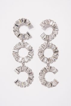 Our Avella 3-Tier Rhinestone Earrings are designed to elevate and enhance any look. The Rhinestone circle design is detailed with an all around different size stones. The post backing allows you to adjust this to your best fitting. Its the perfect everyday piece. SizeHeight : 5 in.Width: 1.4 in. QualityPost Backing Fit. Coating for quality endurance. ImportedEY12243 Pearl Shop, Holiday Essentials, Pearl Set, Circle Design, Rhinestone Earrings, Pearl Ring, Fascinator, Headpiece, Tiara