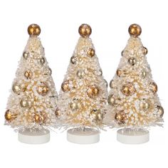 three small white christmas trees with gold ornaments