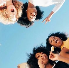 three women standing in a circle with their mouths open and one woman brushing her teeth