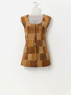 70s vintage tan patchwork suede vest. This 1970s handmade waistcoat in tan features a stunning patchwork pattern, a square neck and a snap button closure. Made from a mid-weight butter soft suede. Our recommended size: Medium Label says: No size label Condition: Good*. Small marks on front and back. Please see last images (not colour accurate) Material: No care label, confident it is suede Measurements in inches: Pit to pit: 19 Shoulders: 16 Front length: 27 Back length: 26 Hem: 22 *Imperfection Fitted Patchwork Vest For Fall, Brown Patchwork Vest For Fall, Retro Patchwork Vest For Fall, Vintage Brown Vest With Button Closure, Suede Vest, Vintage Patchwork, Patchwork Patterns, Vest Outfits, 70s Vintage