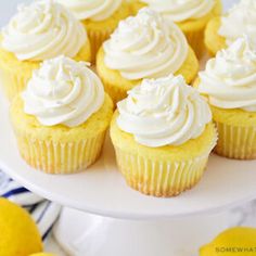 cupcakes with white frosting and lemons in the background