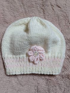 A lovely cream, hand knitted hat with pink flower and stripe details.  Lovely and soft for extra comfort  Ideal for 0-3 months  Wash at 40o Cute Soft White Hat, Cute White Soft Knit Beanie, Cute Cream Soft Knit Hat, Cute White Knitted Bonnet, Cute White Knitted Hat, Cream Beanie Hat As Gift, Cute White Knitted Beanie, Cute Cream Knitted Hats, Hand Knitted White Hat Gift