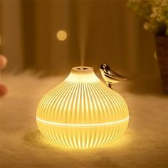 a bird is sitting on top of a yellow light bulb that has been turned on