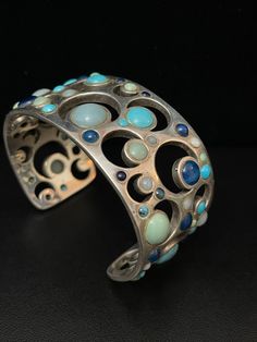 Vintage 1980s Cuff Bracelet  Celebrating the Crescent Moon,  Sterling Silver, Blue Moon,  Turquoise, Lapis, Chalcedony Gorgeous. With Signature Stamp Weight 2.7 oz Open studio most days 10:00 to 5:00, DM make an appointment to have an adventure in shopping. Yes ~ along with basic simplicity ~ It's all about you You deserve to know about my fabulous Treasure chest. Tribal Jewelry, Statement Piece Handmade Jewelry, Art to Wear, with Much Much More. Looking for more Treasures, Or would like to purc Unique Blue Oval Cuff Bracelet, Unique Blue Nickel-free Cuff Bracelet, Vintage Turquoise Cuff Bracelet, Southwestern Style Blue Nickel-free Cuff Bracelet, Signature Stamp, Vintage Nickel-free Turquoise Cuff Bracelet, Wedding Jewelry Bracelets, Crescent Moon, Multi Stone