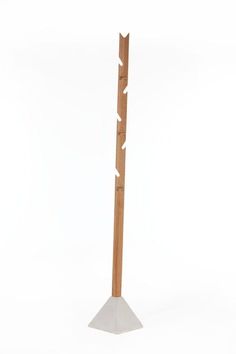 a tall wooden pole sitting on top of a white floor