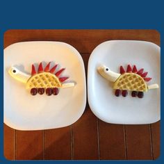 two plates with food shaped like dinosaurs on them