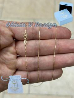 14K Solid Yellow Gold Box Necklace Chain 0.50mm Stamped: 14K Average Weights: *16"   .65 Grams *18"   .73 Grams *20"  .80 Grams *22"  .86 Grams *24"  .95 Grams *26"  1.03 Grams *28"  1.09 Grams *30" 1.17 Grams Lock: Ring Clasp Arrives in a Velvet Gift Pouch and includes FREE SHIPPING to the USA To see more chains and other handcrafted jewelry collections, please visit my storefront here : https://www.etsy.com/shop/OliviaVdesigns About OliviaVDesigns: Thanks for taking a look at Olivia V. Designs Gold Box, Necklace Box, Box Chain, Chain Styles, Layered Necklaces, Gold Chains, Chains Necklace, Handcrafted Jewelry, My Jewellery