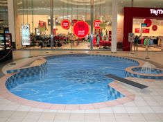 an empty swimming pool in the middle of a shopping mall