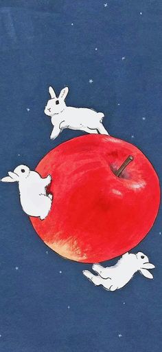 an apple with two rabbits on it and one rabbit running across the top, in space