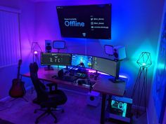 a computer desk topped with monitors and speakers