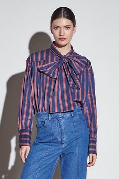 This long-sleeved red and blue-colored striped shirt features wide cuffs and a lace detail that allows endless styling possibilities. The perfect versatile piece to elevate your looks. Made from high-quality materials, this shirt offers both timeless style and durability. With its wide cuffs and lace detail, you can create a variety of looks for any occasion. From casual to formal, this versatile piece is a must-have for any wardrobe. Coastal Americana, Blue Striped Shirt, Overalls Pants, Striped Fabric, Wide Cuff, Wide Sleeves, Summer Sale, Striped Shirt, Shades Of Blue