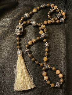 Necklace Profile: 🔱Our Mala skull chains are made of real stones and 925 silver beads to create an everlasting dark show-off necklace. The brown version is made of Bronzite stones and silver beads and a realistically sculpted Guru skull bead cast in heavy 925 sterling silver. It comes with a silk or leather tassel to complete the look. Bronzite stones are believed to have the properties for increasing self-esteem, promoting decision-making, dispelling negativity and enhancing creativity. 🔱 Eac Pagan Jewelry, Amulet Necklace, Wrist Wear, Skull Necklace, Beaded Skull, Chain Silver, Engraved Jewelry, Leather Tassel, Decision Making