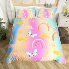 a bed room with a neatly made bed covered in colorful comforter and pillow cases