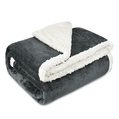 a blanket that is laying on top of a white surface with a black and grey color scheme