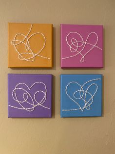 four square paintings with white string in the shape of hearts