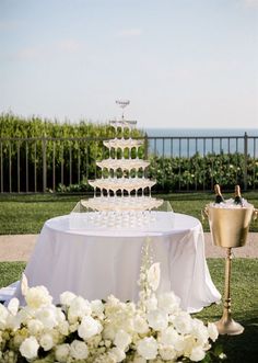 a wedding cake sitting on top of a table next to a vase filled with flowers