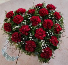 a bouquet of red carnations on the floor