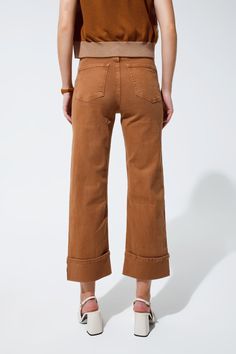 Introducing the epitome of versatile fashion: our Straight Leg Jeans in a rich camel hue. These jeans blend the timeless straight-leg silhouette with contemporary folded trouser legs, creating an effortless style that can transition from daytime casual to evening sophistication. Constructed with a blend of 98% Cotton and 2% Elastane, these jeans offer both comfort and durability. The stretch denim ensures a snug fit that moves with you, while the five-pocket design provides ample space for your Tan Scarf, Types Of Jeans, Free Dresses, Straight Leg Denim, Pocket Design, Stretch Denim, Sweater Hoodie, Effortless Style, Straight Leg Jeans