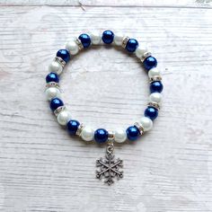 Cute snowflake beaded stretch bracelet. Perfect gift for Christmas or stocking filler. These are great gifts for little girls aswel as adults, you will find matching items in my store. *The bracelets are available for adults and children. Adults measure approximately 7.5inches unless a note is made. Children sizes vary depending on age of child. *The bracelets are made using 8mm glass pearl beads in any colours of your choice and white beads. *In between the beads are silver rhinestone beads to give a little sparkle.  *In the centre is a silver plated snowflake charm. *The charm measures approximately 2cms. ☆☆The bracelet comes presented in a little gift bag, I also have gift wrap and messages available to purchase from my store☆☆ If you have any questions or custom orders please feel free Adjustable Christmas Charm Bracelet For Gifts, Adjustable Charm Bracelet For Christmas Gift, Holiday Gift Charm Bracelet Adjustable, Handmade Bracelets For Holiday Gifts, Christmas Gift Beaded Bracelets With Round Beads, Silver Beaded Christmas Bracelets As Gifts, Silver Beaded Christmas Gift Bracelets, Christmas Beaded Stretch Bracelet Gift, Silver Beaded Bracelets For Christmas Gift