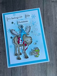 a christmas card with a moose and snowflakes on the front, it's feeling - lot like christmas