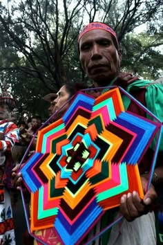 a man holding a colorful umbrella in his hands