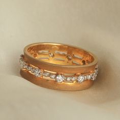 two gold wedding bands with diamonds on them