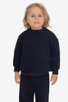 A 14 oz. Heavy Fleece sweatshirt made for kids. Features drop shoulders, long sleeves and a crew neckline. This fleece is very heavy and will provide you with warmth in temperatures as low as 50°F (10°C). These sweatshirts are made in South Central, Los Angeles by expert sewers using premium construction materials and techniques. Made in Los Angeles, Calif. Our experienced sewers earn up to $25 an hour and no less than $17.28; additionally workers have healthcare benefits for less than $15 per w Lace Knitwear, Denim Short Jumpsuit, Made For Kids, South Central, Jumpsuit Jacket, Leather Denim, Fleece Sweatshirt, Construction Materials, Sleeveless Vest