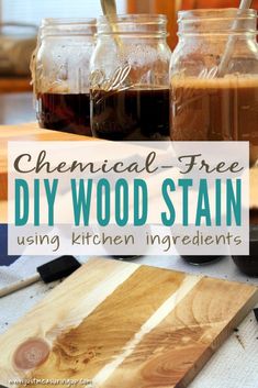 three jars filled with homemade wood stain sitting on top of a cutting board