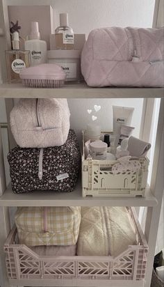 three shelves with towels and other items on them