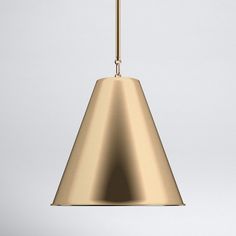 a gold pendant light hanging from a ceiling