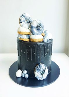 there is a black cake with silver decorations on it