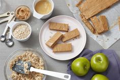 apples, oatmeal and peanut butter are on the table