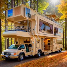 a truck is parked in front of a house shaped like a camper van with stairs on the roof