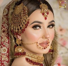 a woman with makeup and jewelry on her face