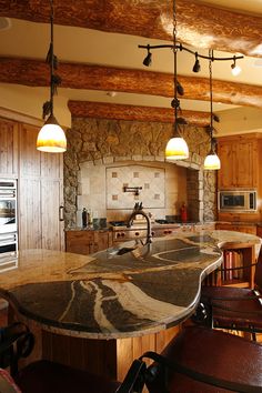 a kitchen with marble counter tops and an island in front of a stove top oven