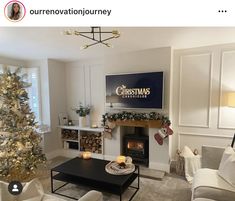 a living room filled with furniture and a christmas tree in front of a tv mounted on the wall