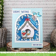 a card with a birdhouse and snowflakes on it