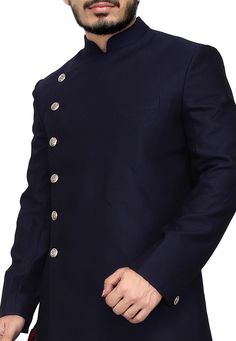 A Long and royal indian ethnic indian wear sherwani especially designed for men in order to make an occasion very especial. It is elegantly made with hands to bring about a feel about India. Look your best on your special day while you carry your sharp attitude with this indowestern sherwani paired with a churidar. Colored in oxford blue color and black embellished with woven work. Available with gold color cotton silk churidar. Slip on to some matching mojari and a matching safa to complete the Traditional Suits For Diwali Semi-formal, Traditional Semi-formal Suits For Diwali, Unstitched Nehru Jacket For Semi-formal Festivals, Fitted Long Sleeve Sherwani For Semi-formal Occasions, Fitted Semi-formal Sherwani, Semi-formal Fitted Long Sleeve Sherwani, Traditional Semi-formal Kurta With Buttons, Traditional Semi-formal Bandhgala With Zari Work, Semi-formal Traditional Bandhgala With Zari Work