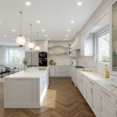 a large kitchen with white cabinets and wood flooring is pictured in this image, there are lights hanging from the ceiling