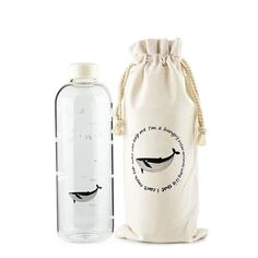 a bottle with a bag next to it that has a whale drawn on the side