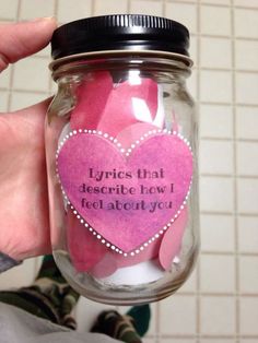 a person holding a jar filled with pink paper hearts and saying it's that describe how i feel about you